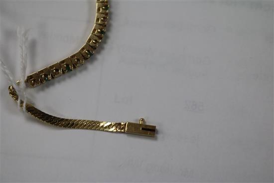 A 14ct gold, emerald and diamond small line bracelet, 15cm.